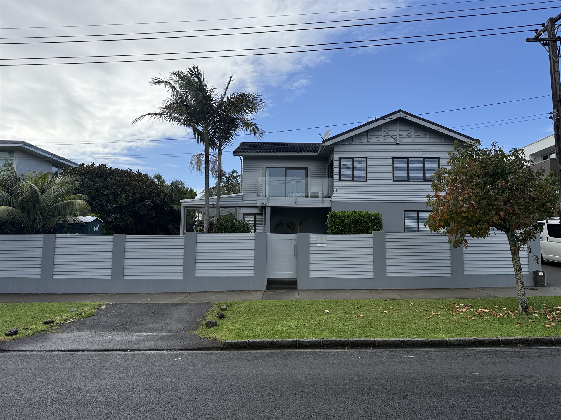 Auckland home after a complete exterior repaint, with repainted weatherboards, fence and gate