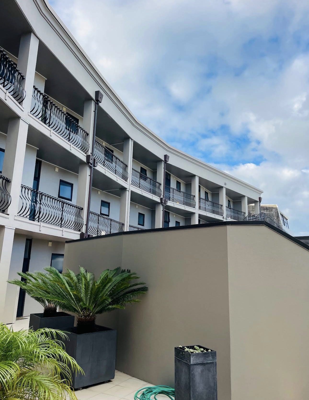 Curved apartment facade after repainting, balconies sweeping around the courtyard