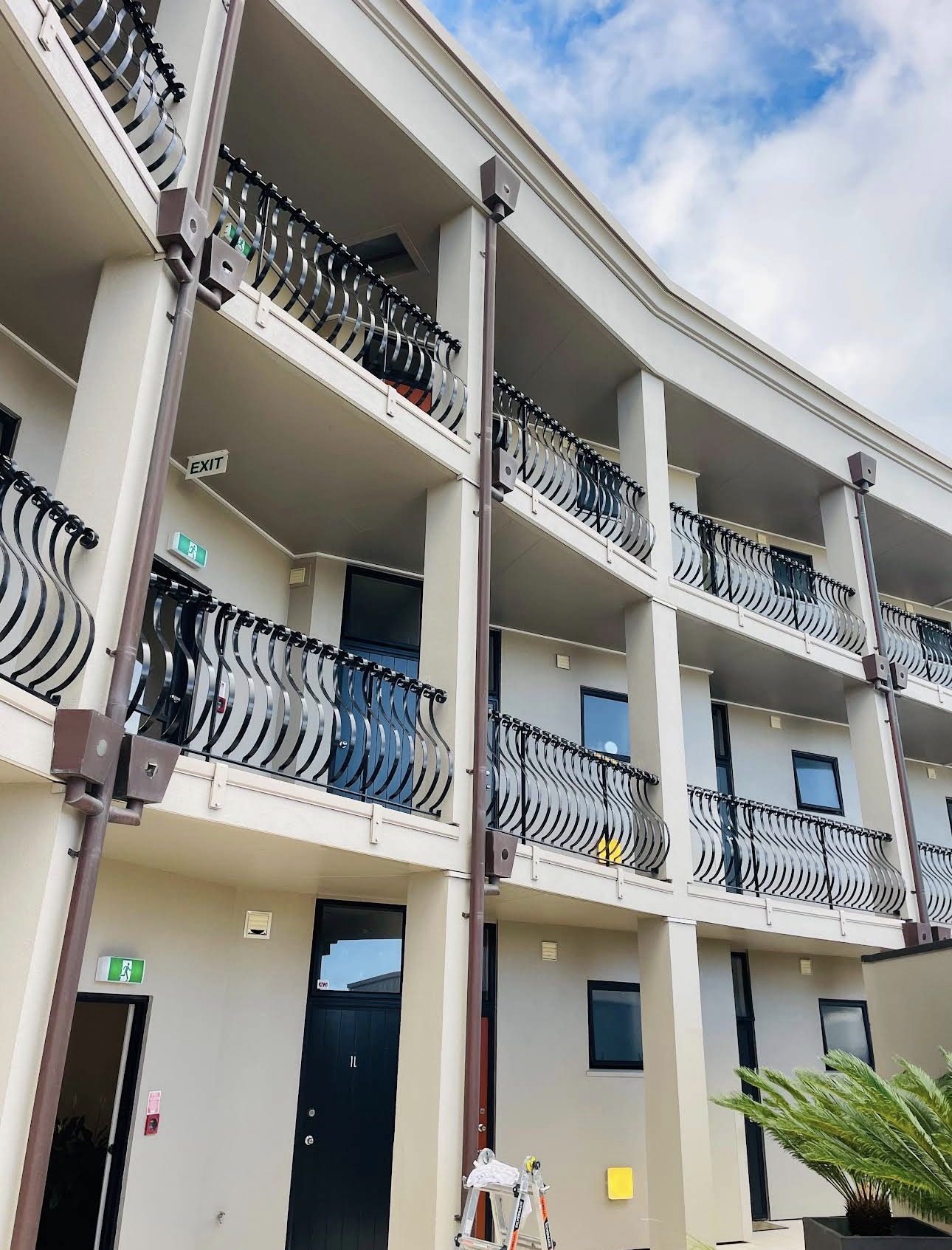 Balcony level with repainted columns, ceilings and apartment entry doors