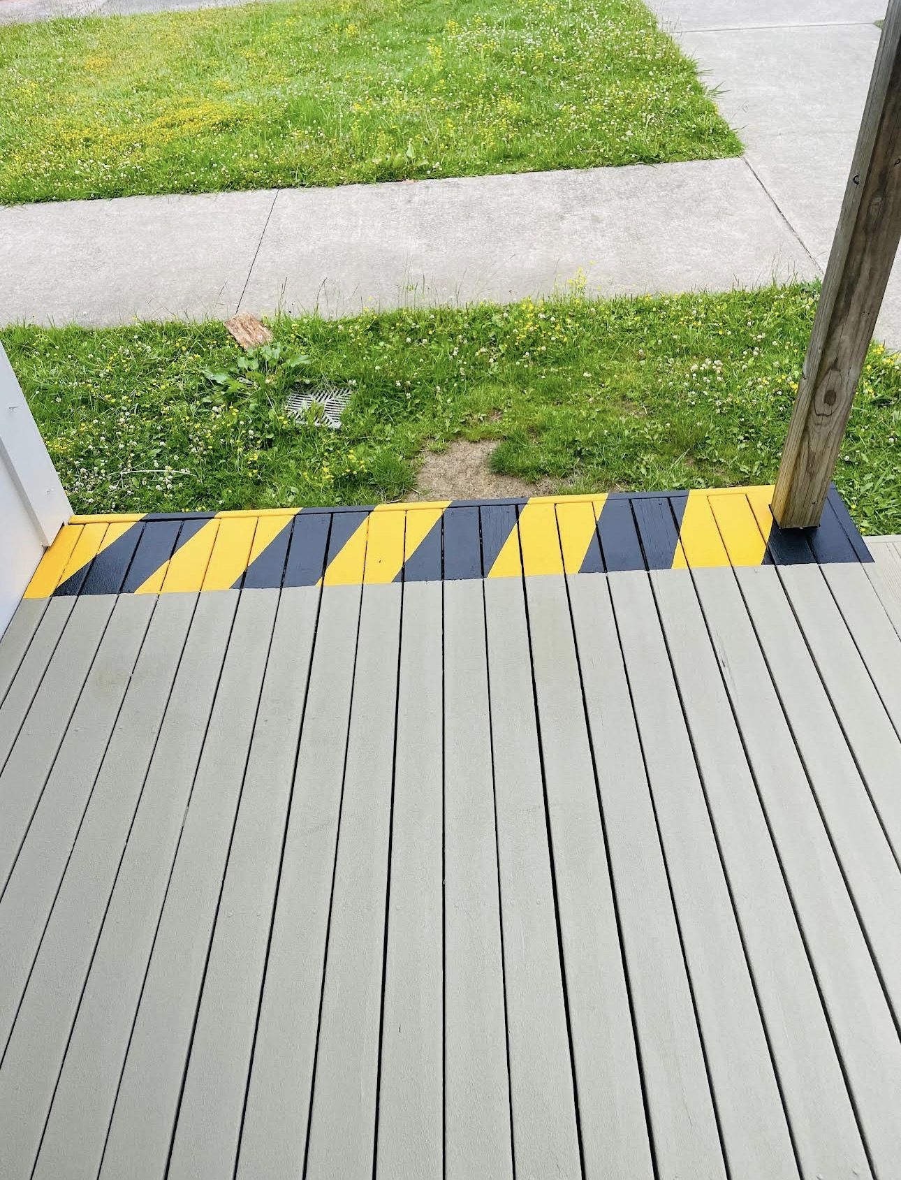 Black and yellow hazard striping marking the edge of a raised school deck